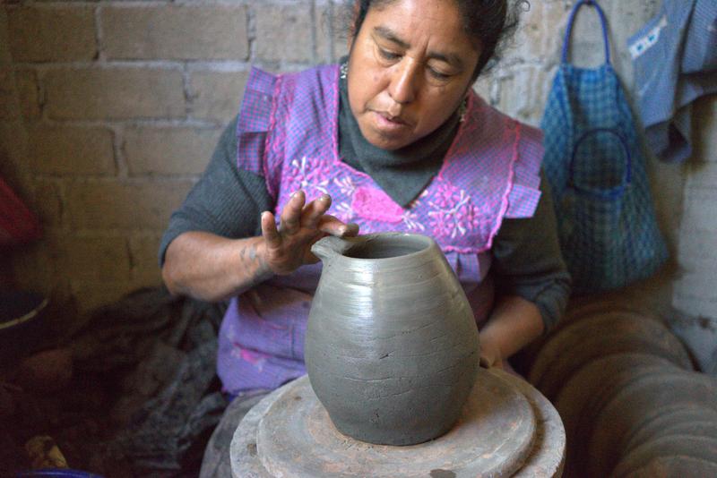 a woman making pottery in Azompa, Oaxaca